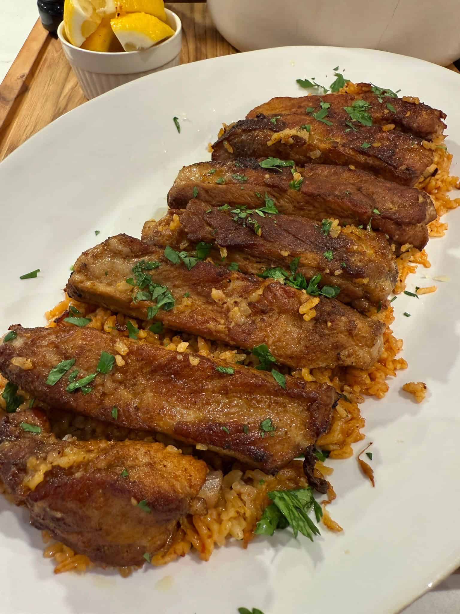 A plate of Portuguese pork ribs and rice.
